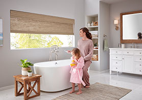 Mother and Daughter in Bathroom Closeing Motorized Shades