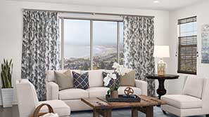 Curtains in a living room overlooking the ocean