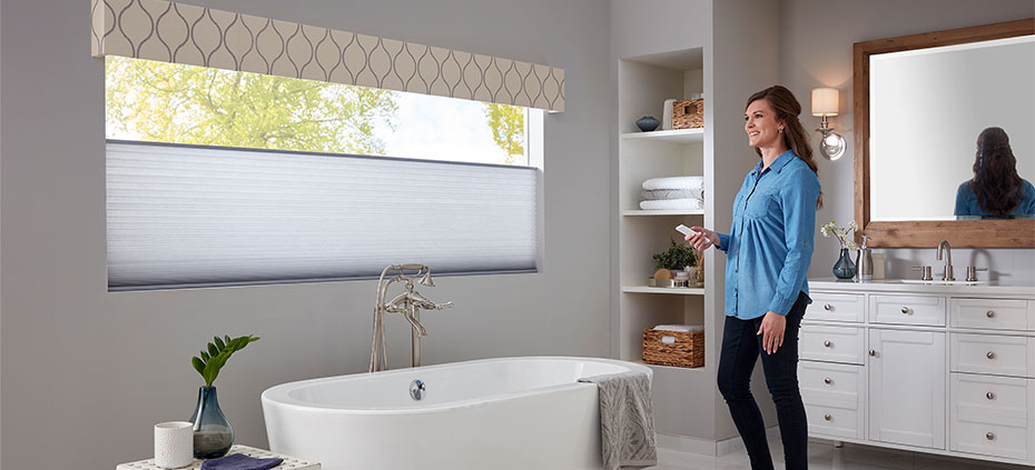Motorized Shades in Bathroom Woman operating remote