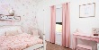 Pink Drapery Panels in Bedroom layered over Roller Shades