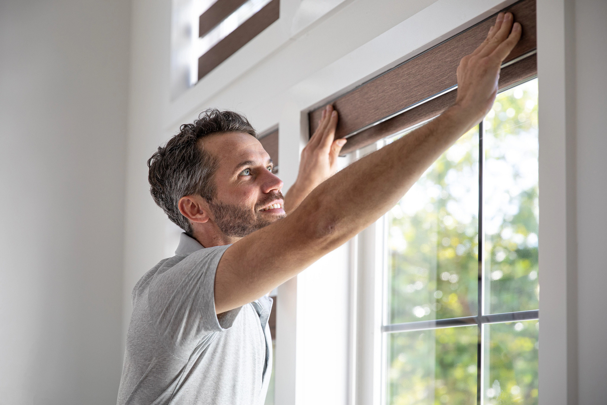 Man installing blinds