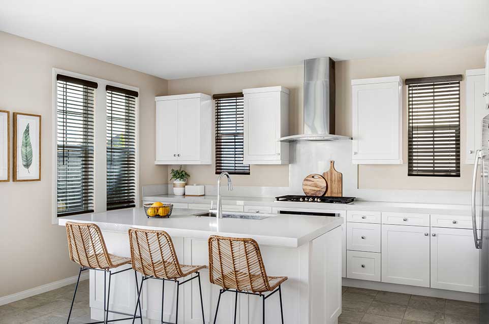 Learn More about the Benefits of Blinds! Faux Wood Blinds in a white kitchen