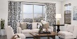 Custom Floral Drapery and Woven Wood window treatments in a living room