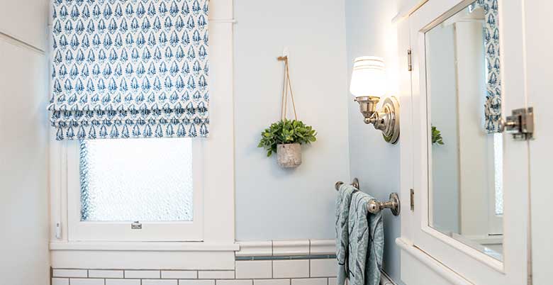 Blue and white soft roman shade in a bathroom