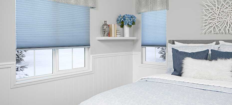 Bedroom in winter with blue cellular window treatments