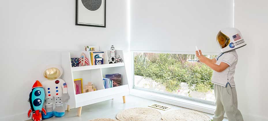 Childs bedroom with child controlling remote controlled roller shades