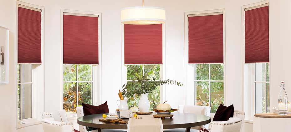Red cellular shades in pristine dining room