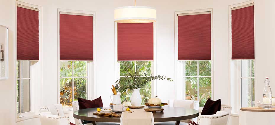 Learn more about the benefits of Cellular Shades Red cellular shades in pristine dining room