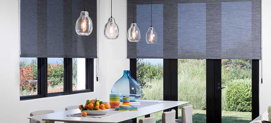 Learn More About the Benefits of Dining Room Roller Shades Grey transparent roller shades in a modern kitchen