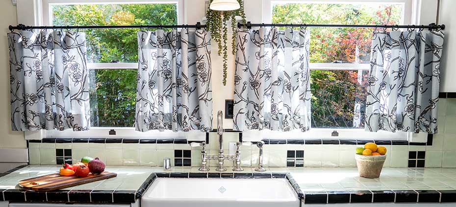 Decorate with statement pieces like cafe curtains! Cafe Curtains behind a sink in a traditional kitchen