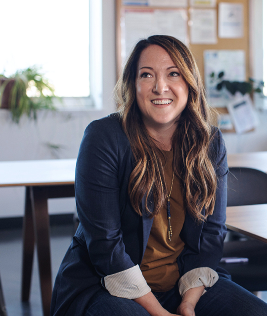 Woman sitting and smiling at an office