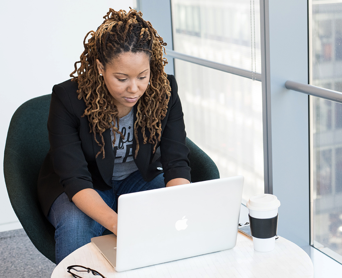 A team member diligently working on her laptop.